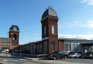 Image of the tower of an old 19th century red brick manufacturing building