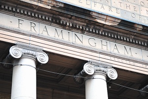close up of Framingham Town Hall entry showing pediment and tops of columns and the word Framingham
