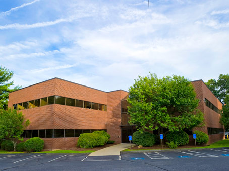 small brick office building with dark glass windows