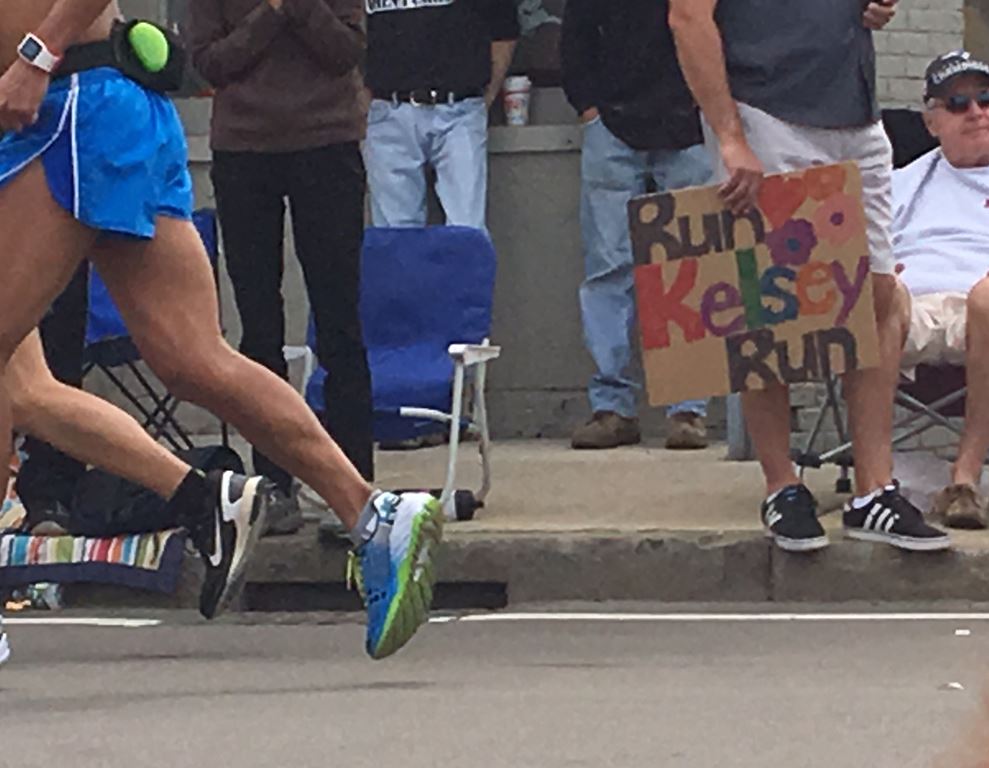 man holding a home made sign on cardboard that says 